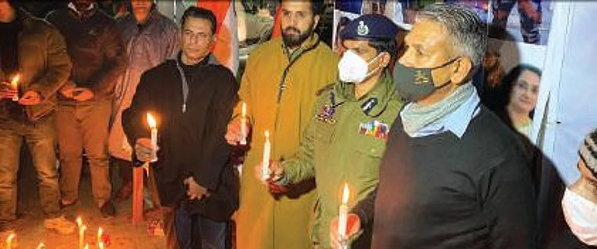 Police and other officials during the candlelight vigil in Srinagar