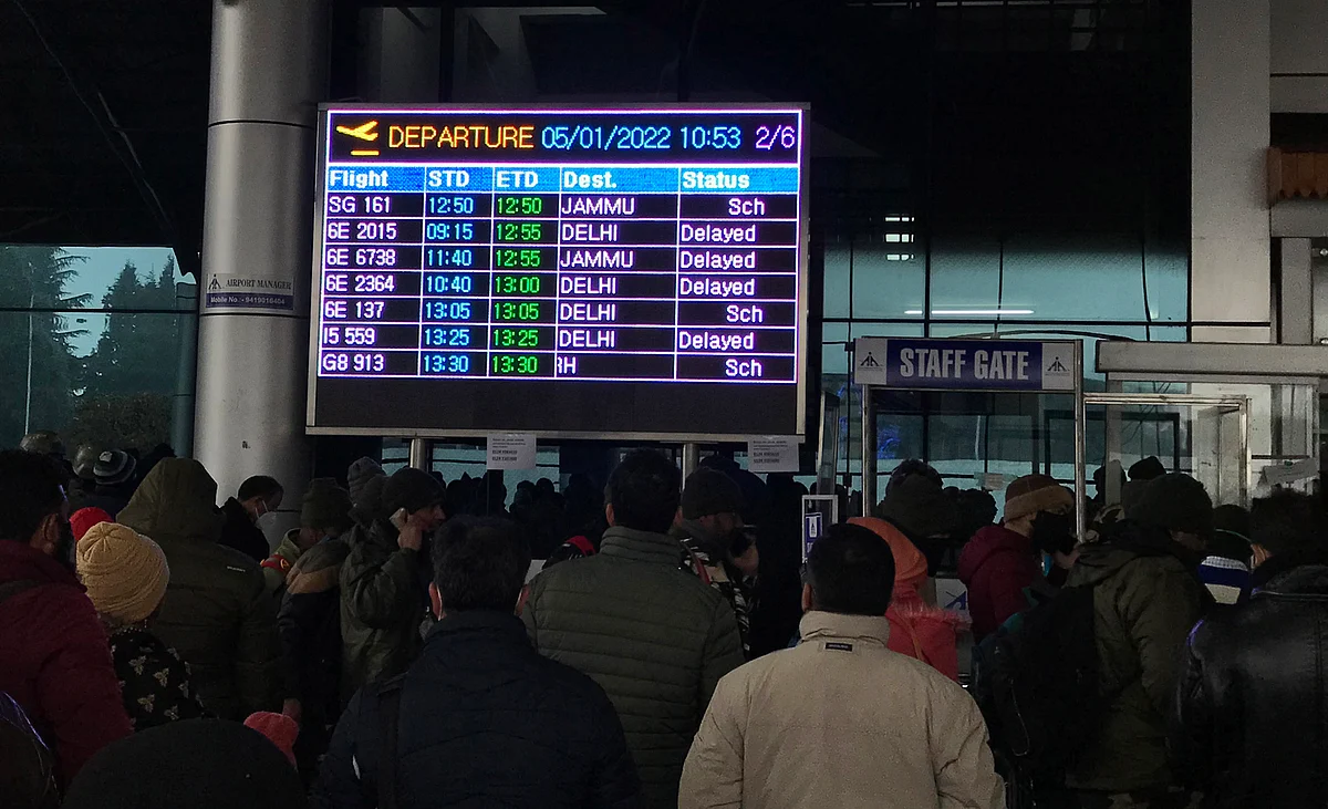 Passengers look keenly at the screen displaying flight status at Srinagar Airport during recent air traffic disruptions created by snowfall in Kashmir.