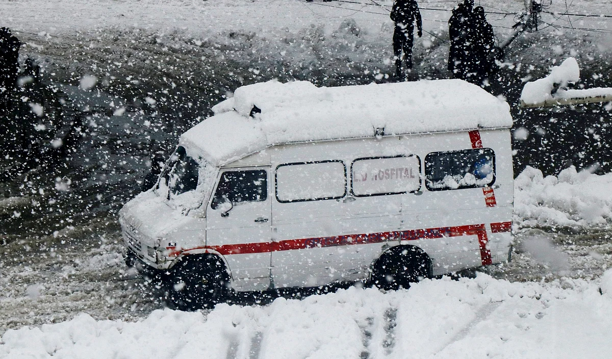 An ambulance moves on a snow covered road in Srinagar as Kashmir woke up to a heavy overnight snowfall on Wednesday February 23, 2022.