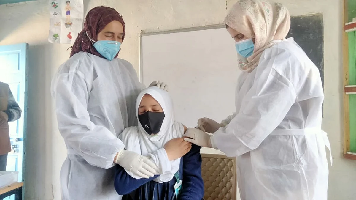 A girl is inoculated against COVID-19 at a school , in Tangmarg area of north Kashmir's Baramulla district, on Wednesday March 16, 2022.