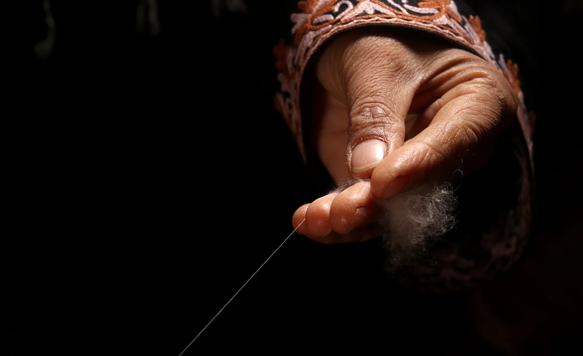 A woman works at a Pashmina centre in Srinagar on Tuesday.