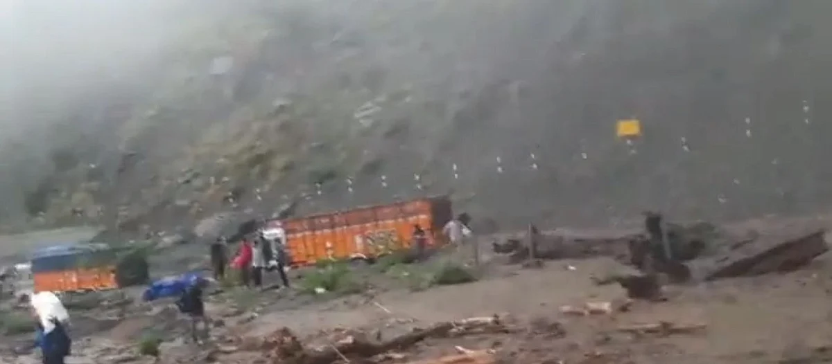 Trucks are seen stuck along Jammu-Srinagar Naional Highway as incessant rains cause massive landslides near Battery Cheshma in Ramban.