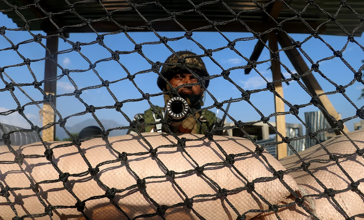 A soldier stands guards inside a bunker along Srinagar-Baltal route as security grid is tightened across Kashmir in view of upcoming Hindu pilgrimage.