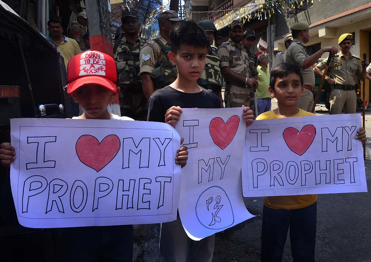 Children hold placard as they protest against now-suspended BJP's spokesperson Nupur Sharma's remarks against Prophet Muhammad (PBUH), in Jammu on 12-06-2022.
