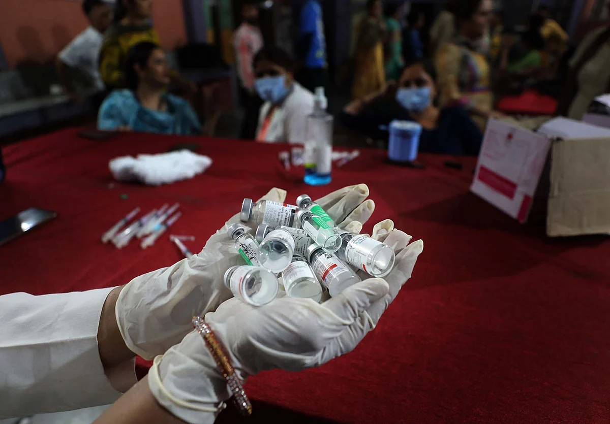 A health worker holds booster doses before jabbing the registered people in Jammu