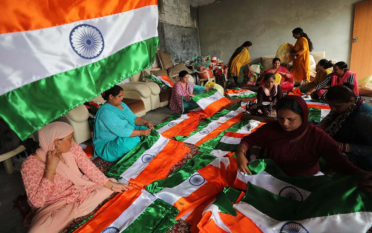 Women tailor Indian flag ahead of Independence day in a border village of Jammu.