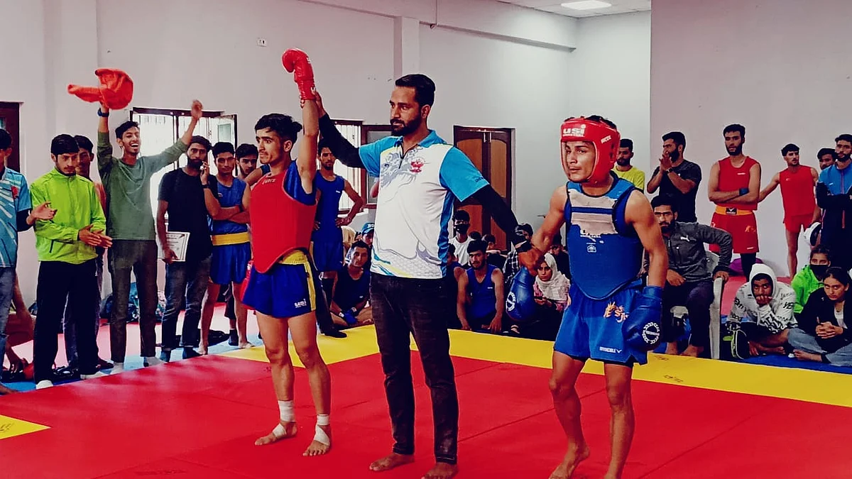 Musharaf Qayoom (L) after winning Wushu Sanda championship