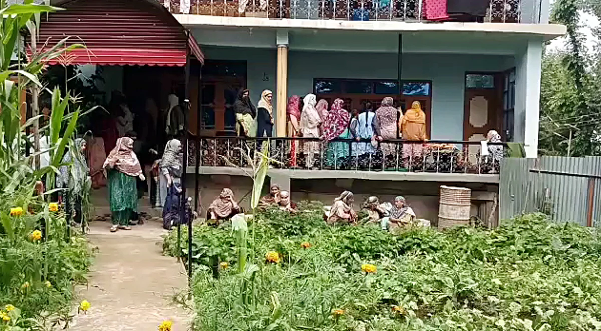 People gather outside the residence of Sunil Kumar, who was shot dead by terrorists at an apple orchard, at Chotipora, in Shopian on Tuesday.