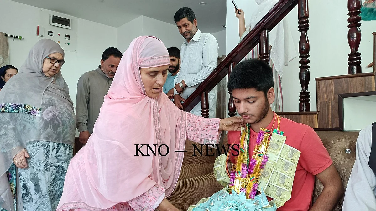Haziq Parveez Lone is garlanded by family after he topped J&K and secured 10th rank in the all-India level NEET UG-examination 2022, at his residence at Trenz Shopian in south Kashmir.