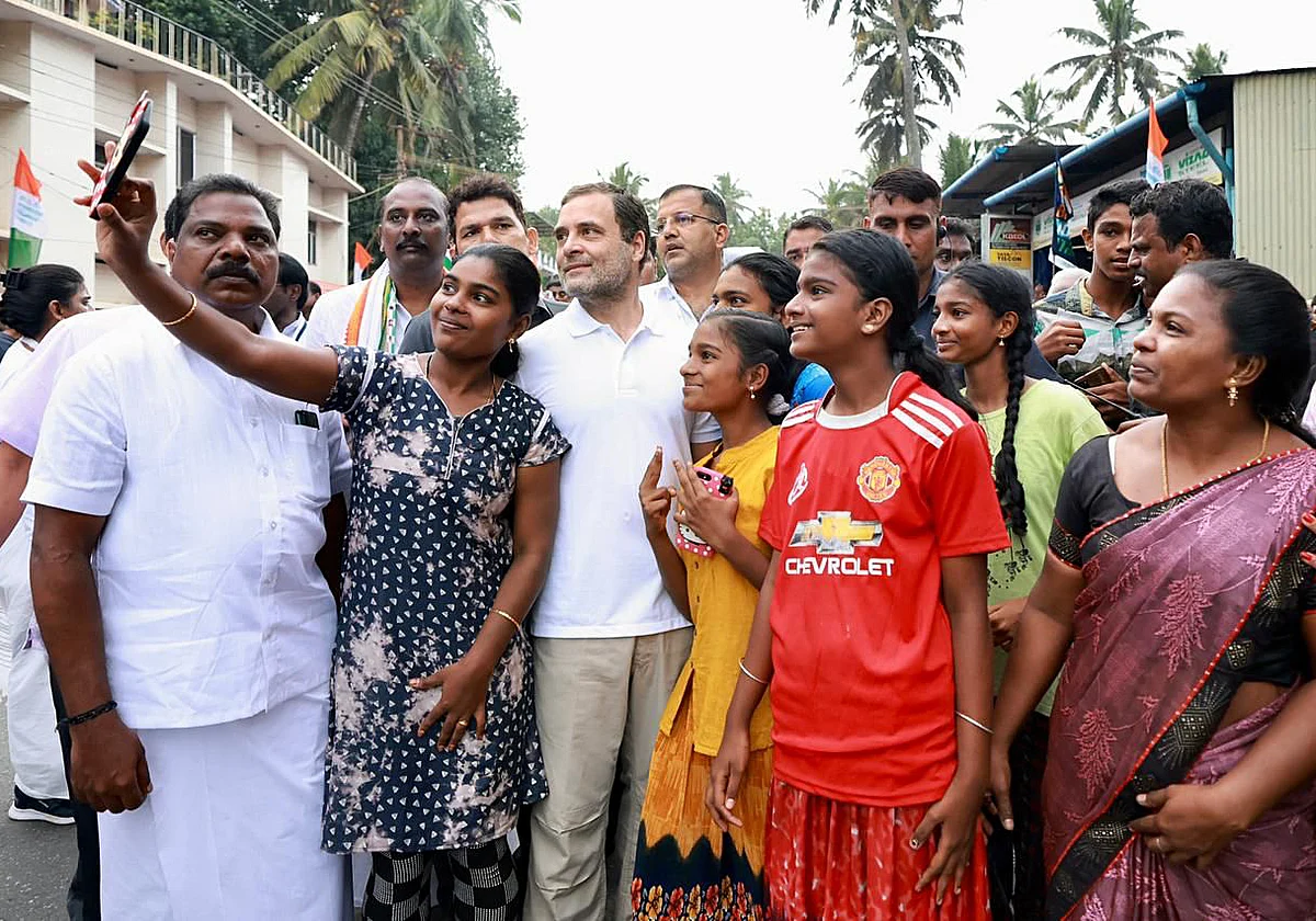 Congress leader Rahul Gandhi poses for a selfie with people during the padayatra on the fourth day of party's Bharat Jodo Yatra, at Mulagumoodu, in Kanniyakumari on Saturday.