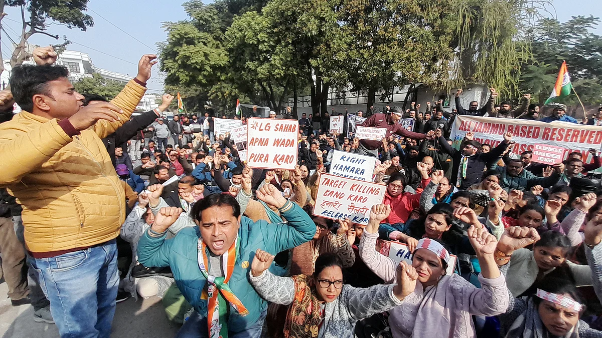 Jammu-based government employees posted in Kashmir sit on a protest demanding their transfer, in Jammu on Thursday.