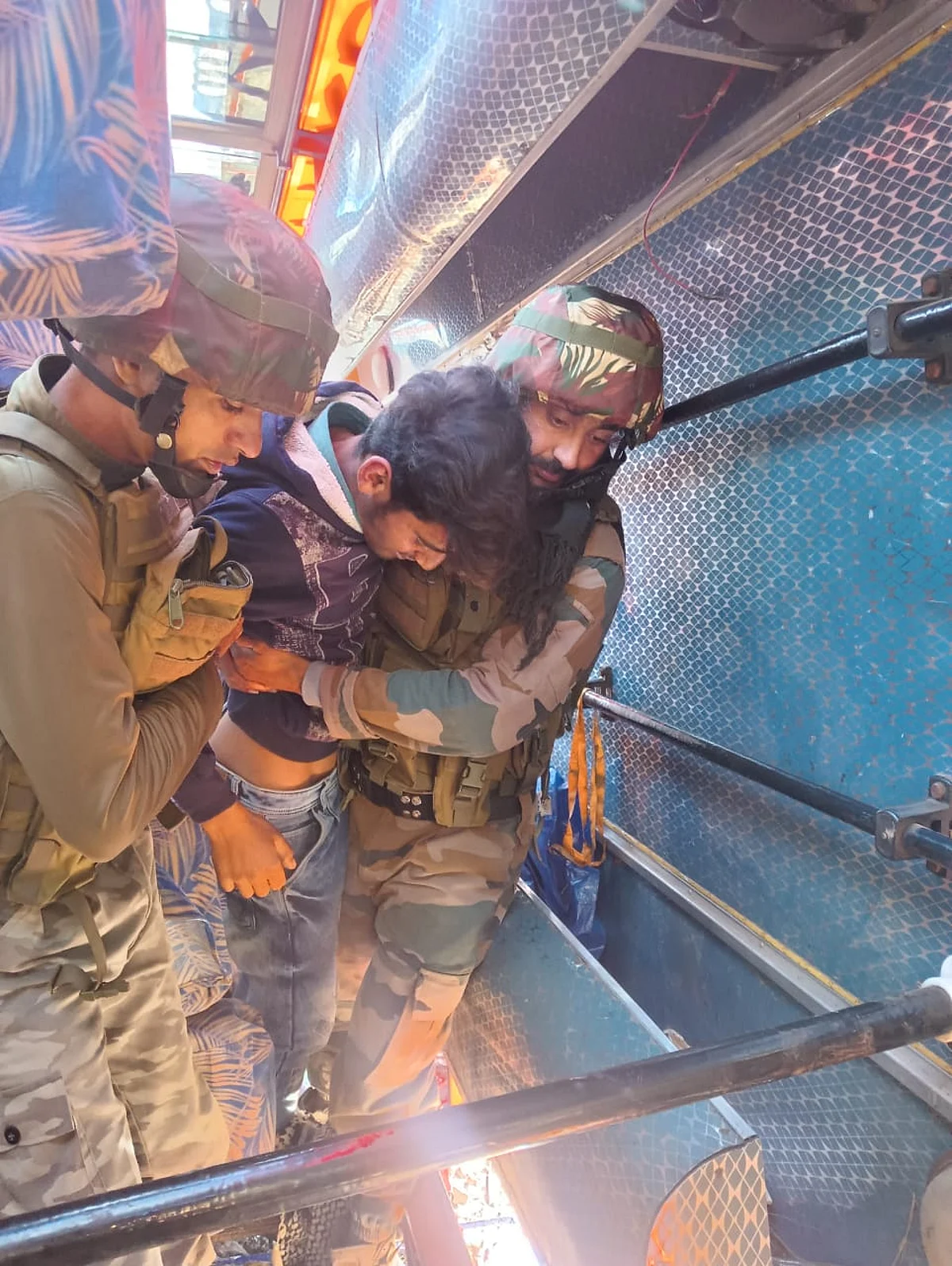 Security forces carrying injured to safety