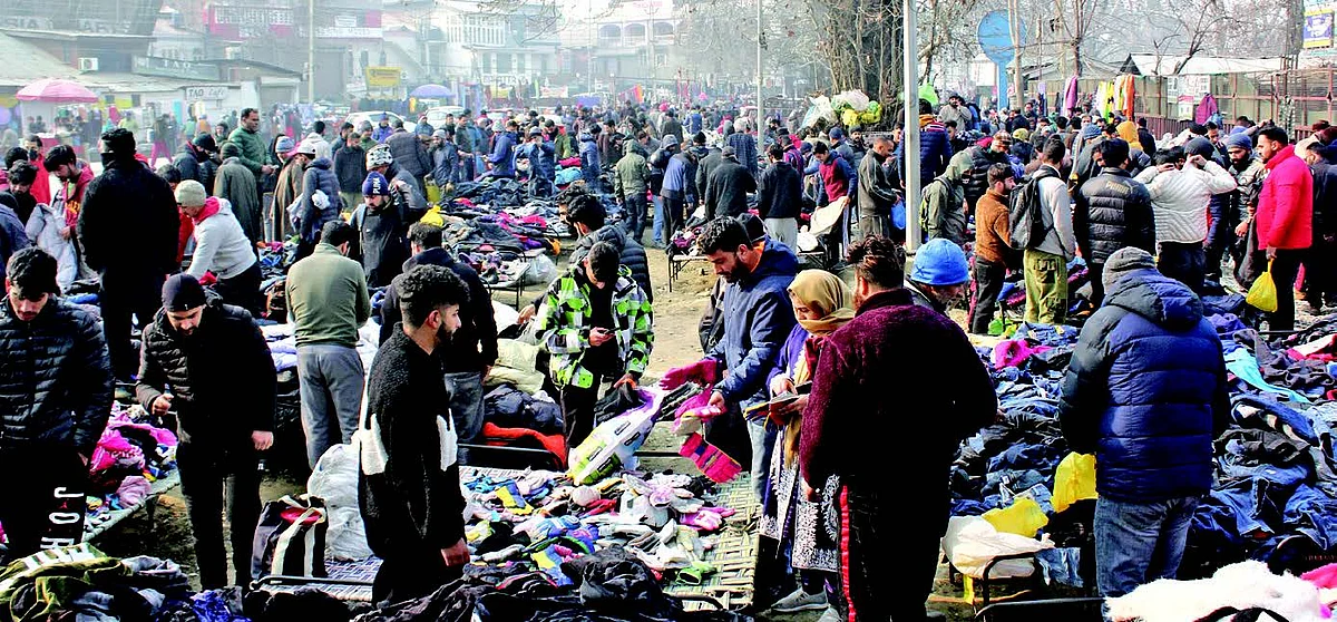 People purchasing winter wear from a flea market as cold wave continues in Kashmir.