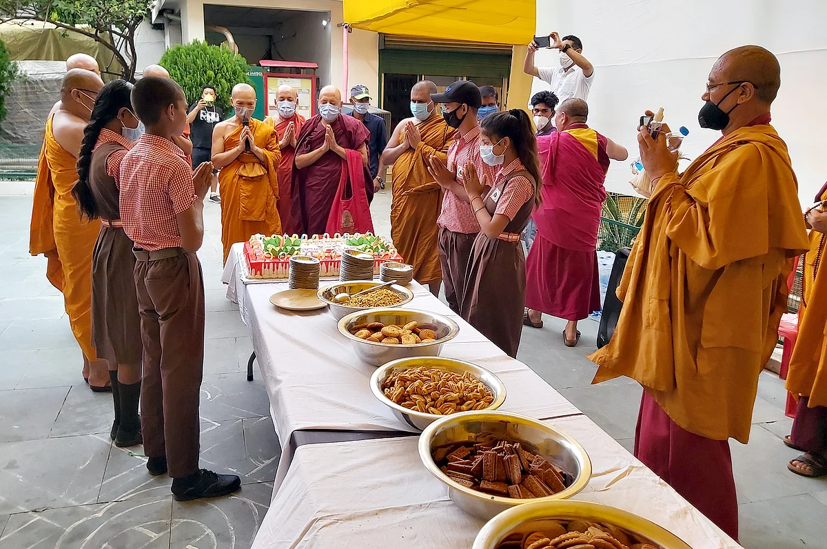Buddhist Monks with Children cuts a cake to celebrate the 85th Birth day anniversary of his Tibetan spiritual leader the Dalai Lama at Tibetan temple in Bodhgaya.