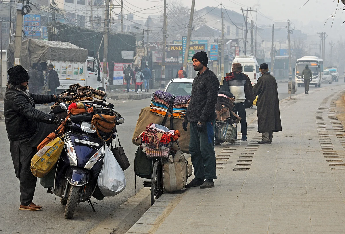 Roadside vendors sell warm clothes on the banks of the Dal Lake on a cold winter morning, in Srinagar on Saturday.