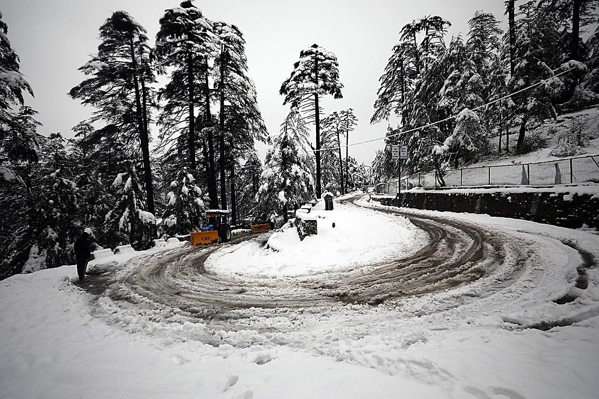JCB machines clearing the snow-covered road at Patnitop.