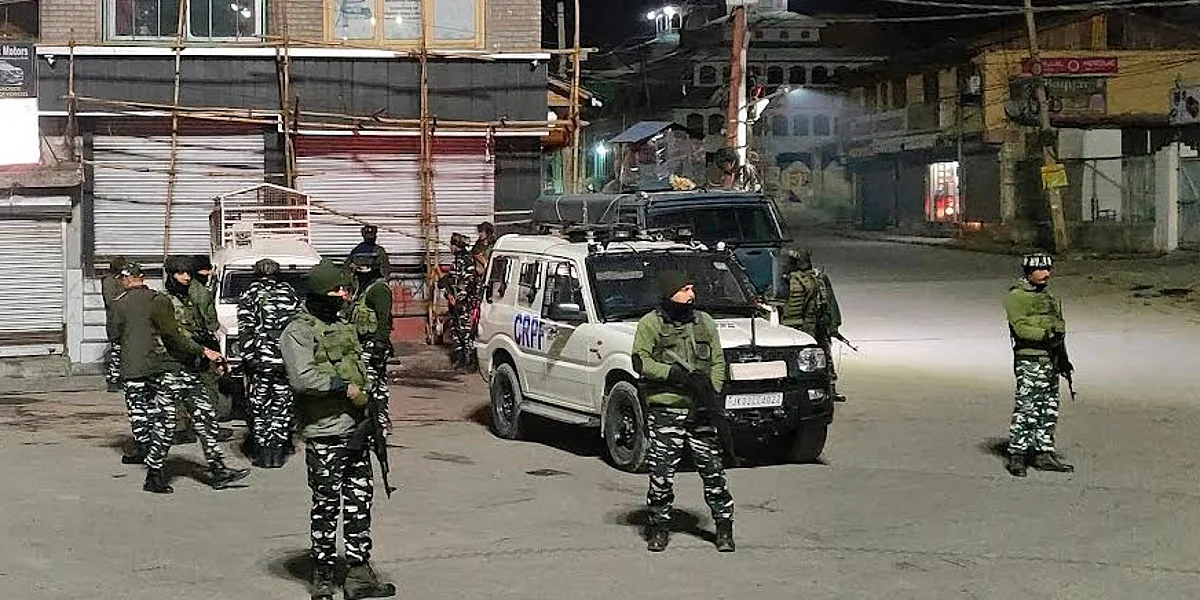 Security forces stand guard after a grenade was lobbed late Sunday evening in Srinagar's Hawal area.