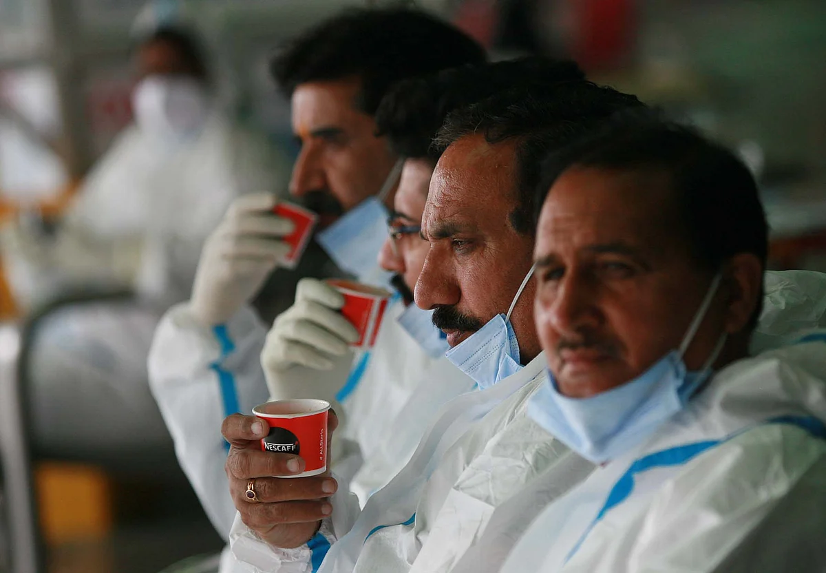 Health workers during a tea break at railway station Jammu.