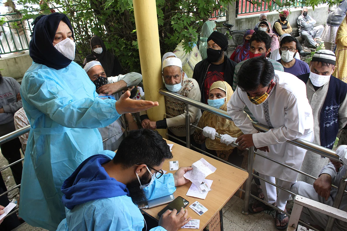 In queue for Covid19 vaccination people flout social distancing at a Health and Wellness Centre in Srinagar, Wednesday, May 5, 2021.
