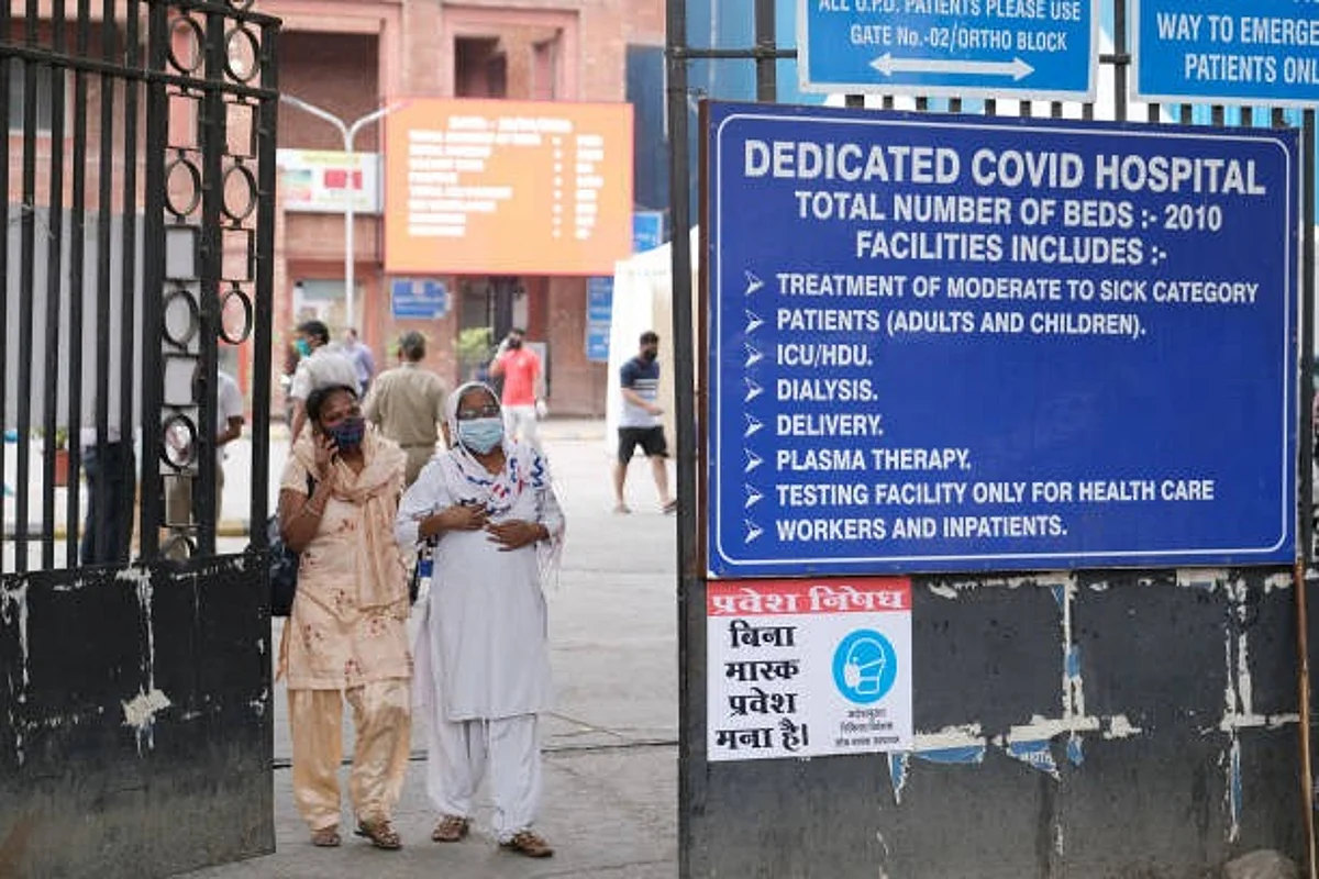 People exit a gate at the Lok Nayak Hospital in New Delhi, India, on Tuesday, April 20, 2021. India now has the worlds fastest-growing Covid-19 caseload, adding 259,170 new infections and 1,761 deaths on Tuesday, leaving it behind only the U.S. in terms of total numbers. Photographer: T.Narayan/Bloomberg via Getty Images