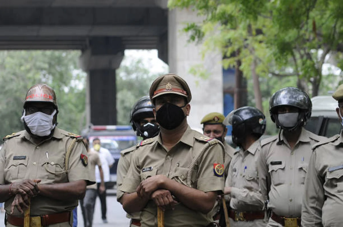 NOIDA, INDIA - JUNE 4: Police personnel look on as BJP party workers sit outside the Sector 24 police station in protest after a local leader was arrested for allegedly harassing a tenant on June 4, 2020 in Noida, India. (Photo by Sunil Ghosh/Hindustan Times via Getty Images)
