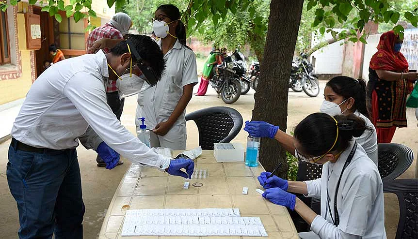 A health worker tests for coronavirus infection at an Ayushman Bharat Health and Wellness Centre. Indian researchers have developed $6 Covid-19 test kits to help with relief efforts.