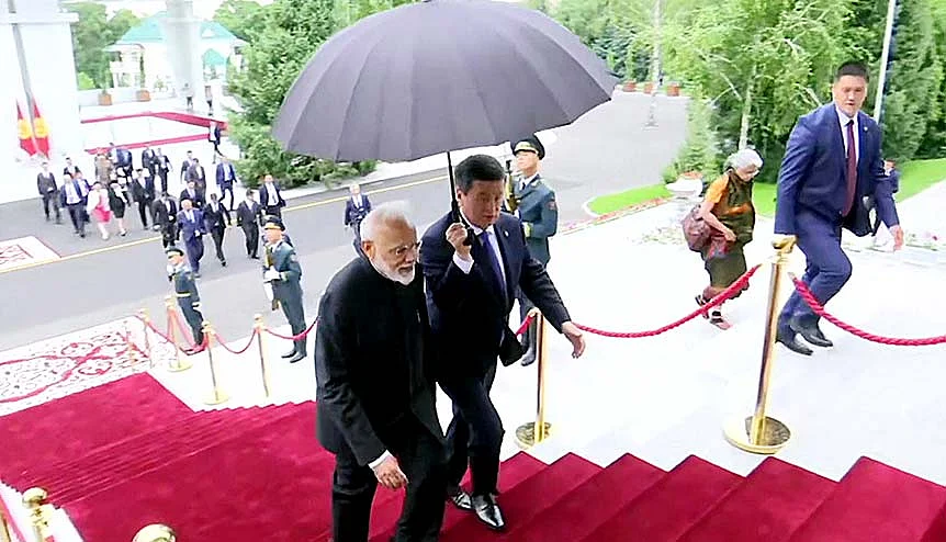 Prime Minister Narendra Modi and Sooronbay Jeenbekov, President of Kyrgyz Republic arrive during the ceremonial welcome at the Ala Archa Presidential Palace in Bishkek last year.