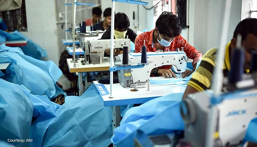 Workers preparing the PPE suits at a private manufacturing unit in Vijaywada, India. The Indian government should use the positive post-pandemic sentiment to push for bigger reforms in manufacturing.