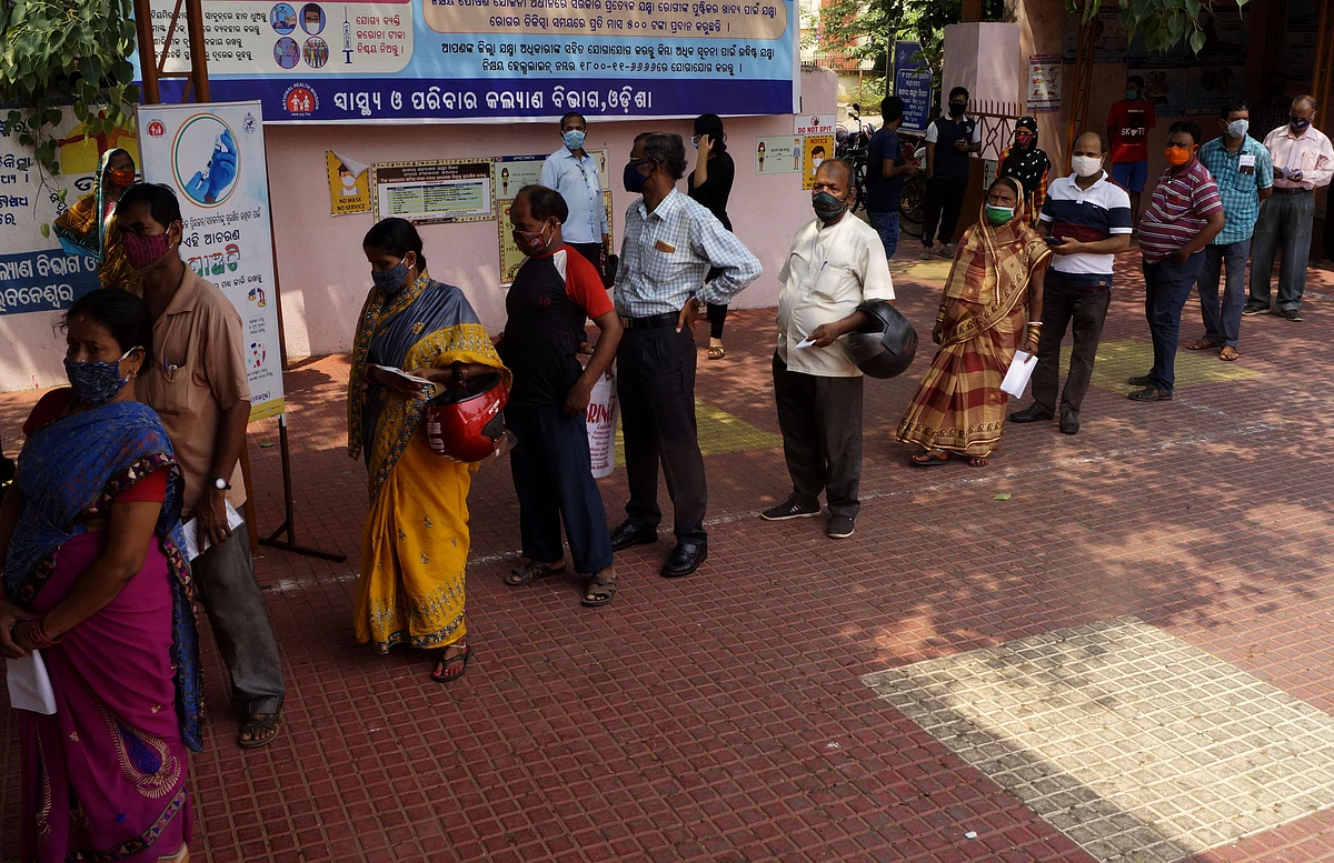 People queue up to buy medicine. According to Fitch Ratings, sales for drug makers in the near term will be boosted by demand for Covid-19 related drugs, particularly in India.