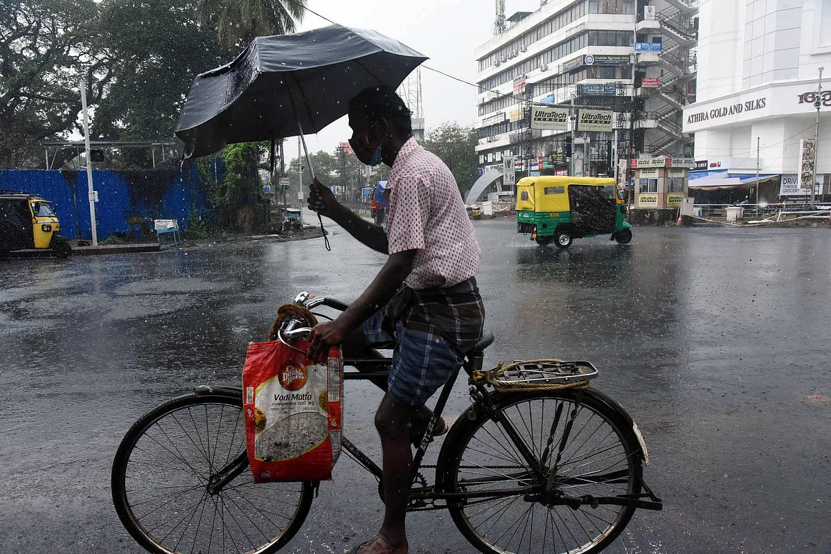A cyclist drives home in the rain. The onset of the monsoon could, thus, herald the much-awaited turnaround for the Indian economy.