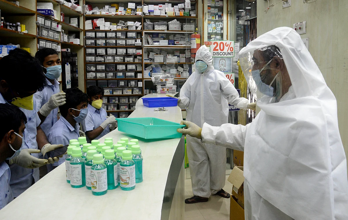 Pharmacy shop workers wear full protective gear suits to serve customers during the nationwide lockdown. The pharmaceutical sector is expected to grow almost by three times in the coming decade, reaching almost $120 billion to $130 billion by 2030.