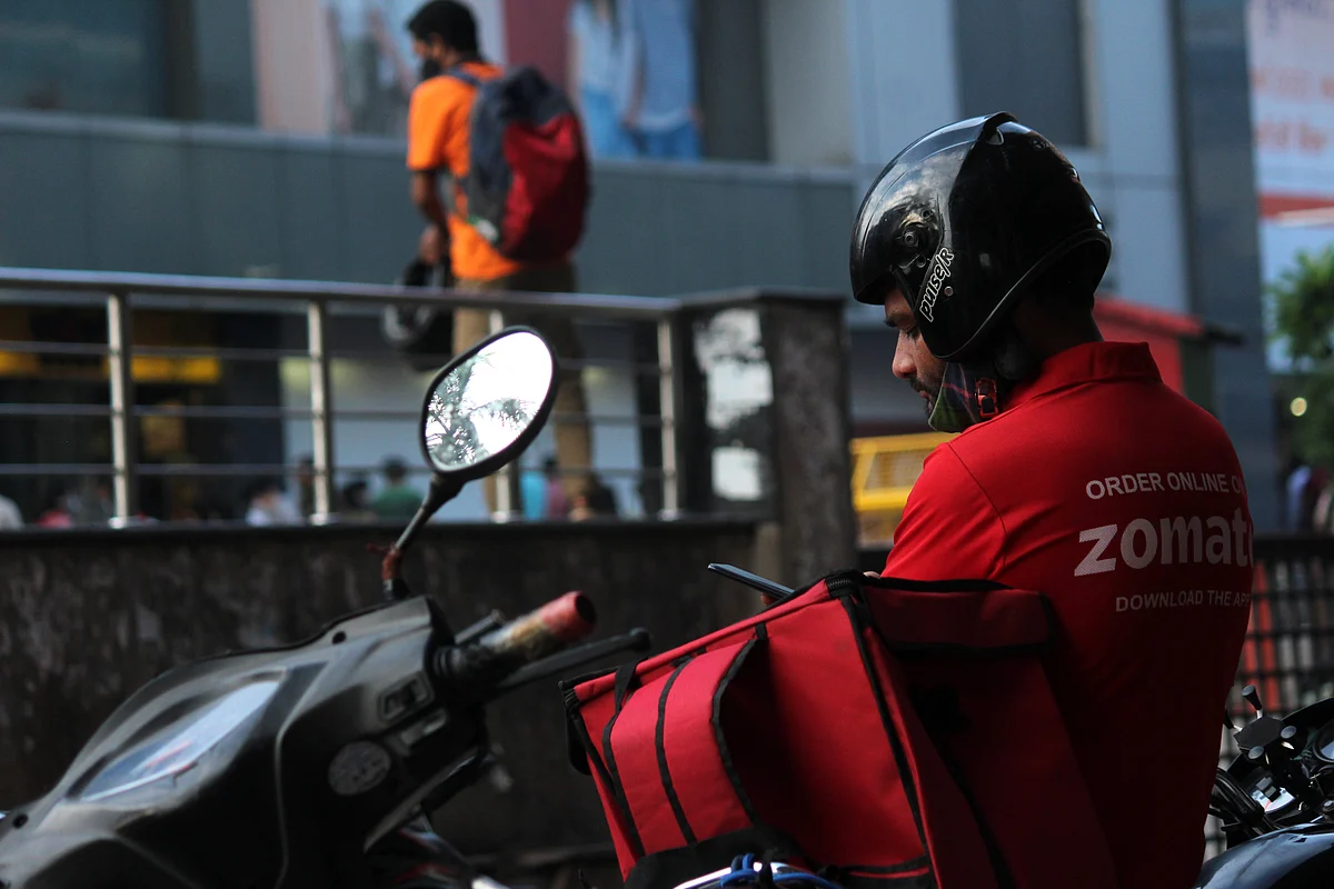 A delivery boy of Zomato, an Indian food-delivery startup, waits outside an outlet to collect orders, in New Delhi, India. Zomato’s stock is currently up 75 per cent over its IPO price.