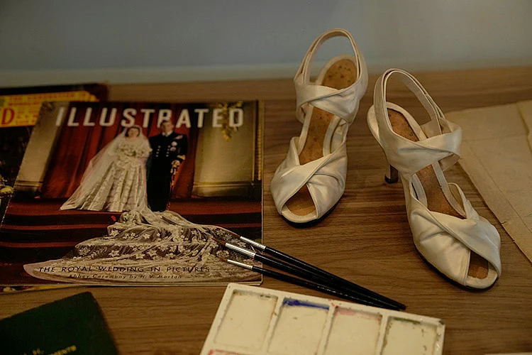 Prototype shoes for the ones Britain's Queen Elizabeth II wore at her wedding are displayed.