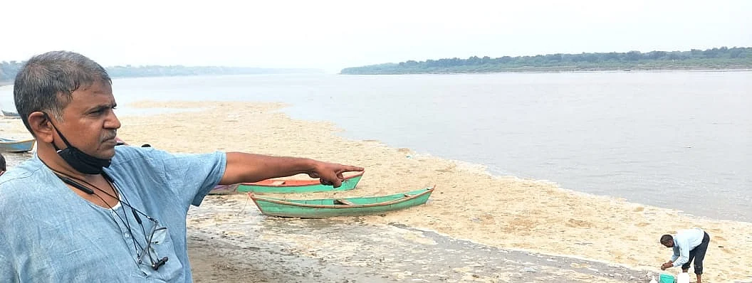 Prajapati at Mahi river, as an activist collects sample
