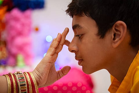 applying tilak on the forehead