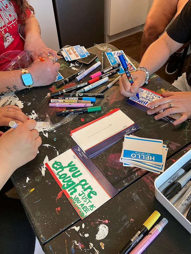Women work on an art project at Sanctuary Night.