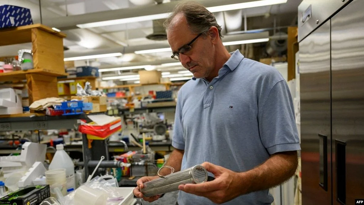 Biology professor John Dennehy holds a tool for wastewater collection at a lab in Queens College, Aug. 25, 2022, in New York. Since a polio case was identified in July in New York's Rockland County, the disease has been detected in New York City sewage (Image Source- VOA)