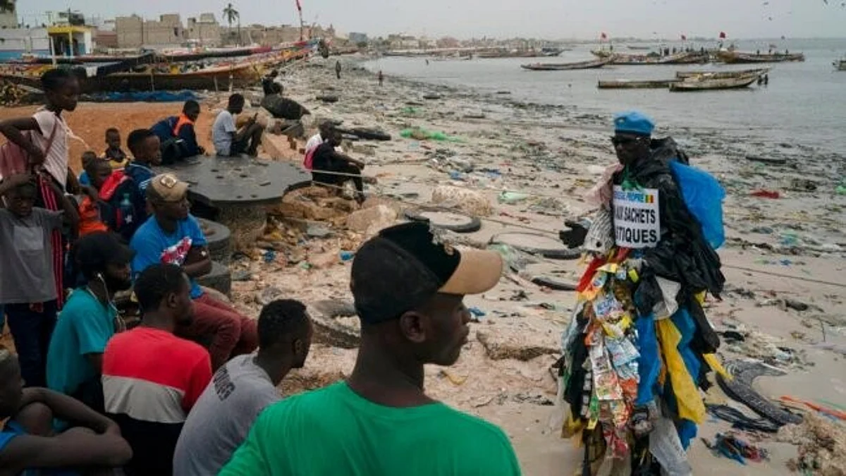 Man is trying to raise awareness about the dangers of plastics — by wearing many of the bags, cups etc. (Image: VOA)