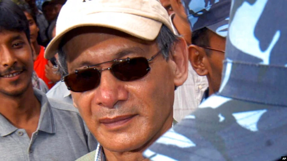 FILE - Police escort convicted French serial killer Charles Sobhraj from court in Katmandu, Nepal, on Aug. 12, 2004.