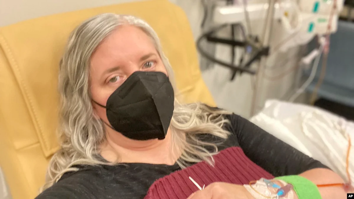 This photo provided by Amy Watson of Portland, Ore., shows her during an iron infusion in December 2022.