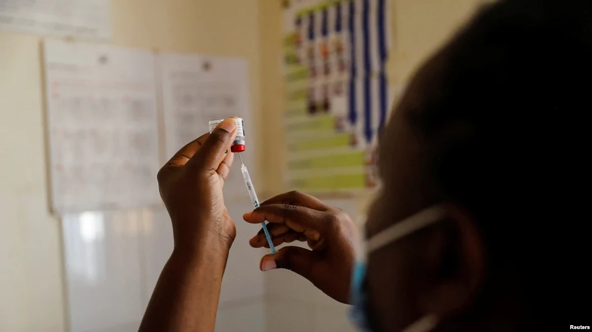 FILE - A nurse fills a syringe with malaria vaccine before administering it to an infant at the Lumumba Sub-County hospital in Kisumu, Kenya, July 1, 2022.