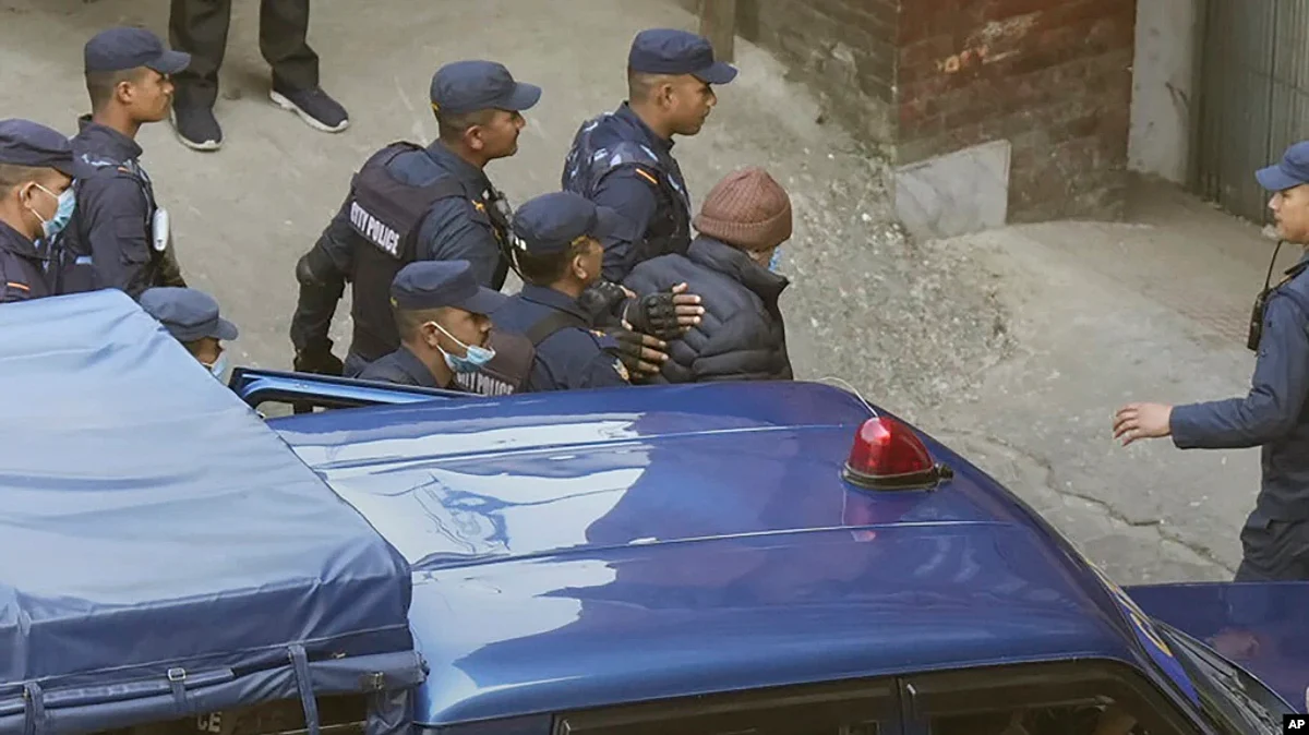 Nepalese police escort Charles Sobhraj, in brown cap, to the immigration office, in Kathmandu, Nepal, Dec. 23, 2022.