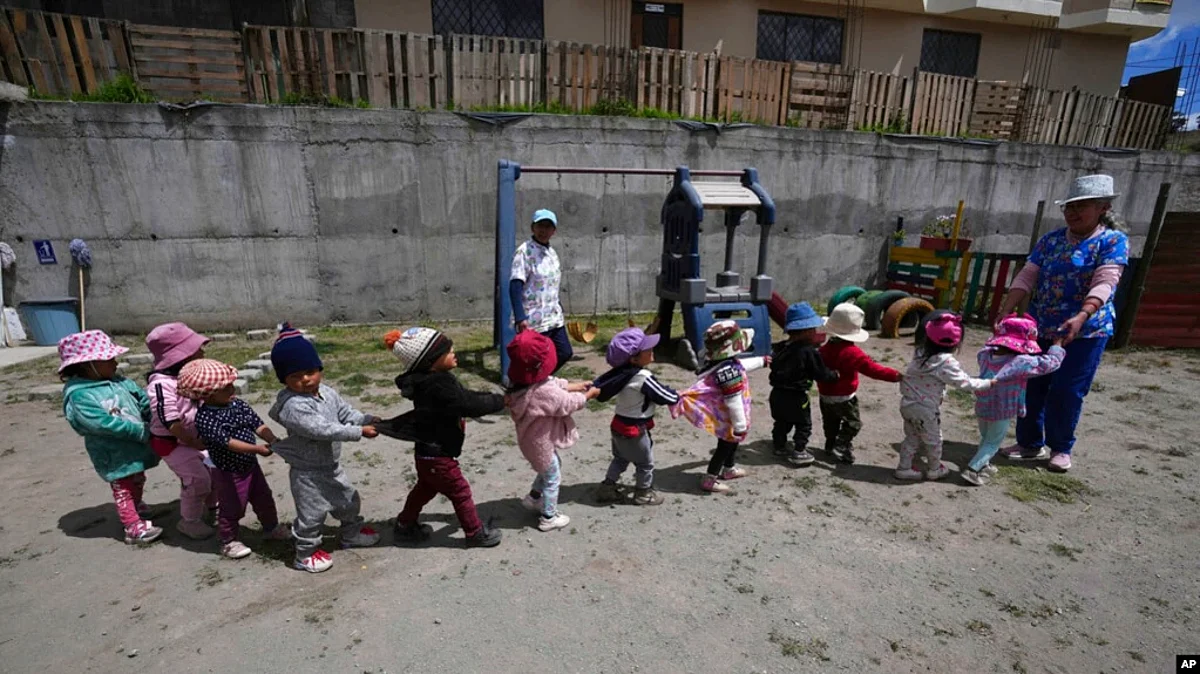 Children play during recess at a government-run daycare where they are fed one meal at lunch time in Catzuqui de Velasco, a rural area without reliable basic services like water and sewage, on the outskirts of Quito, Ecuador, Dec. 1, 2022.