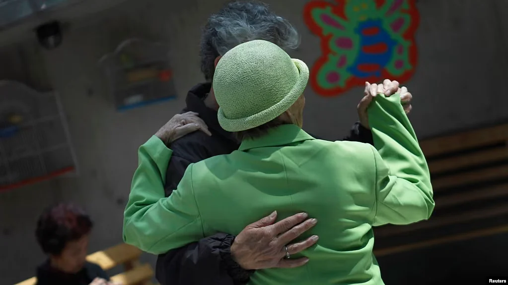 FILE - Patients with Alzheimer's and dementia dance inside the Alzheimer Foundation in Mexico City, April 19, 2012.
