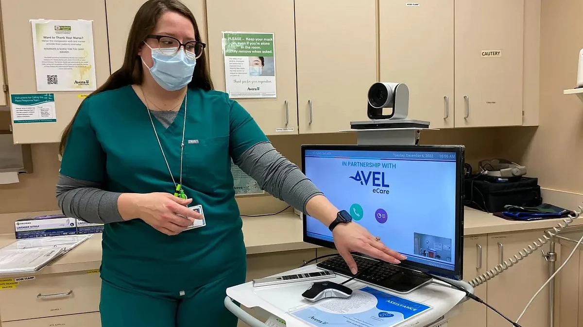 Nurse Lindee Miller stands in front of the mobile cart used for telehealth appointments for sexual assault exams at Avera St. Mary’s Hospital in Pierre, South Dakota. The camera allows Miller and her patient to communicate with a remote nurse trained in such exams.