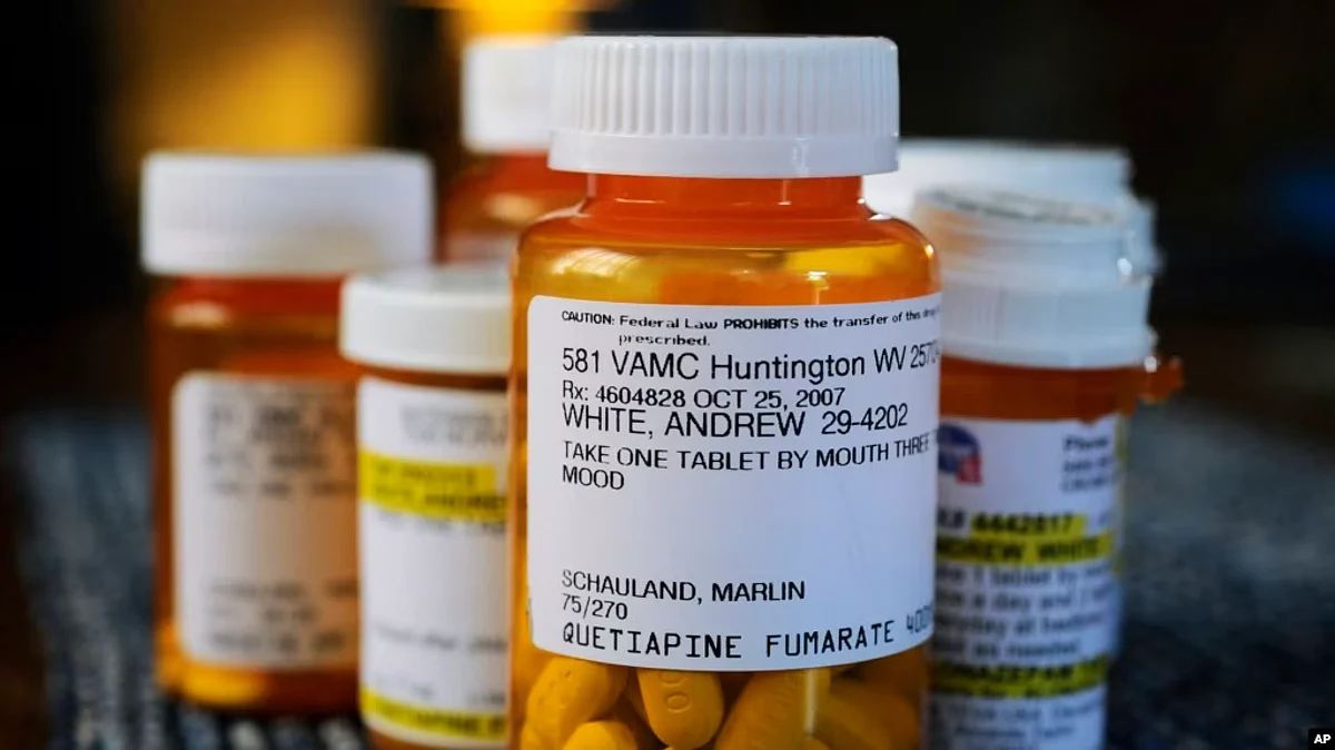 FILE - Several bottles of prescription medications including quetiapine, the chemical name for the drug Seroquel, sit arranged on a kitchen table at a home in Cross Lanes, W. Va., May 26, 2010.