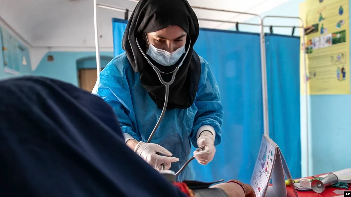 FILE - A midwife from NGO Save the Children provides Zarmina, 25, who is five months pregnant, with a pre-natal check-up, in Jawzjan province in northern Afghanistan, Oct. 2, 2022. (Save the Children via AP)