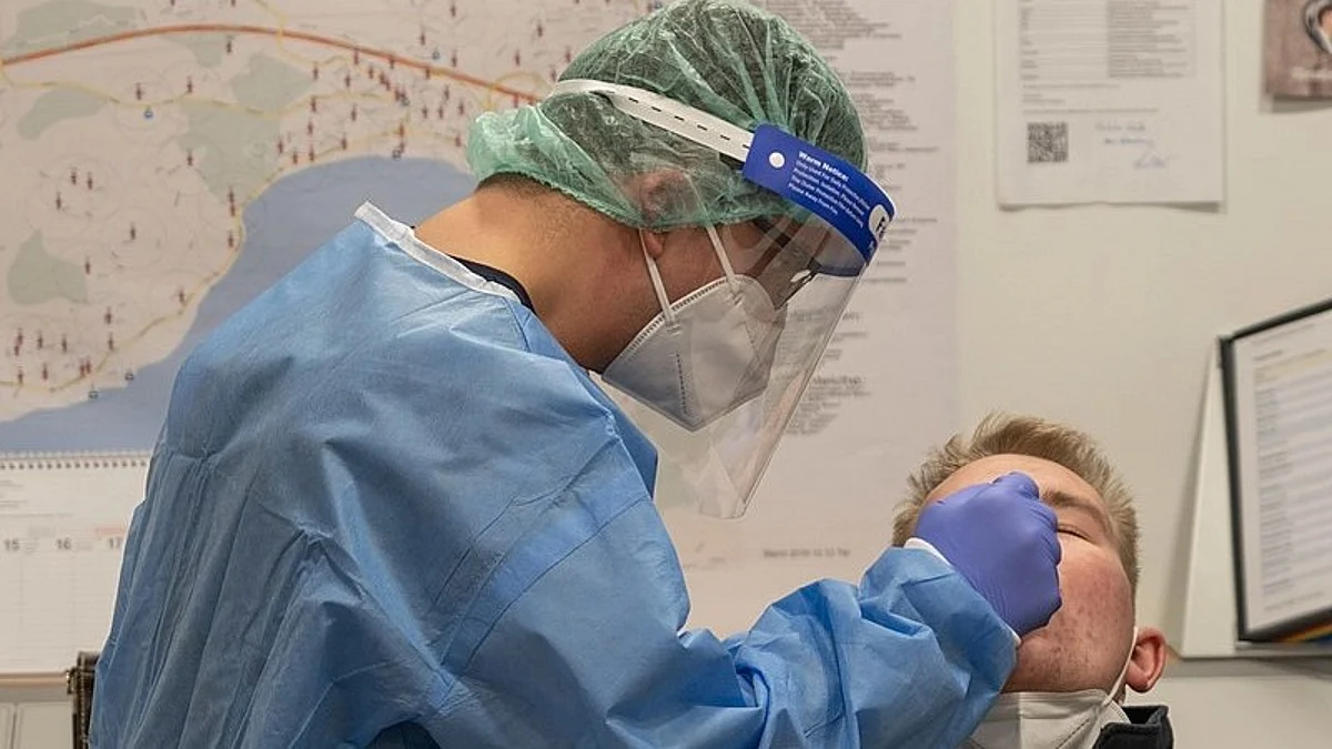 Health care professional taking a swab. Wikimedia Commons