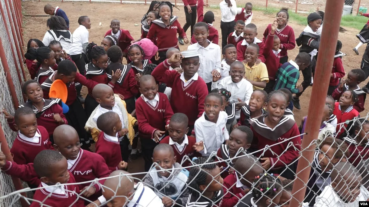 Students, visibly excited, are seen gathered at their school's opening, at Michiru View School in Blantyre, Malawi.