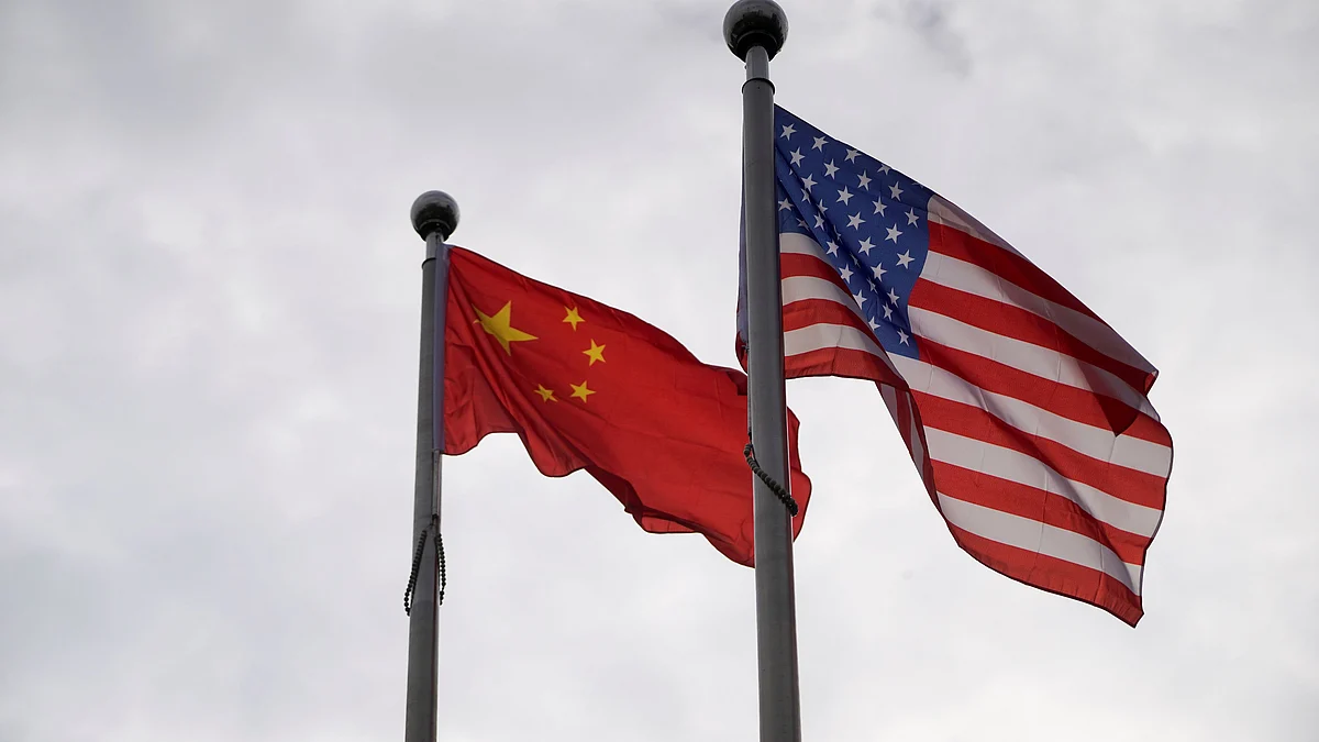 FILE PHOTO: Chinese and U.S. flags flutter outside a company building in Shanghai, China November 16, 2021.